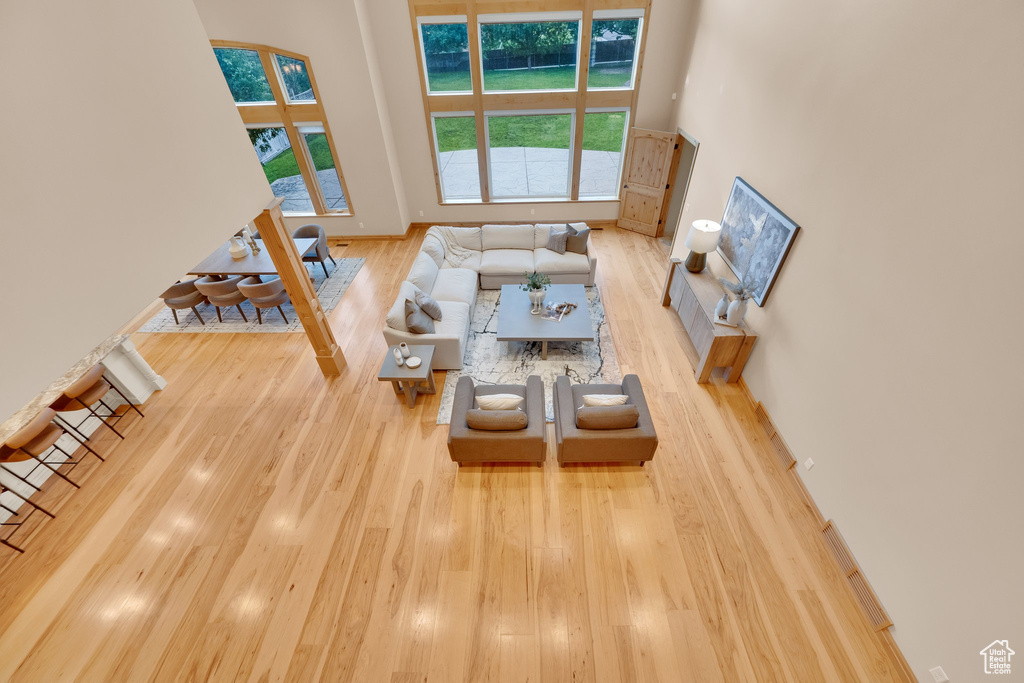 Living area with wood finished floors and a high ceiling