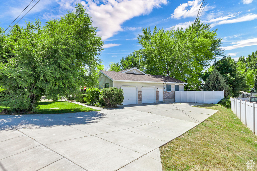 View of side of property featuring a garage and driveway