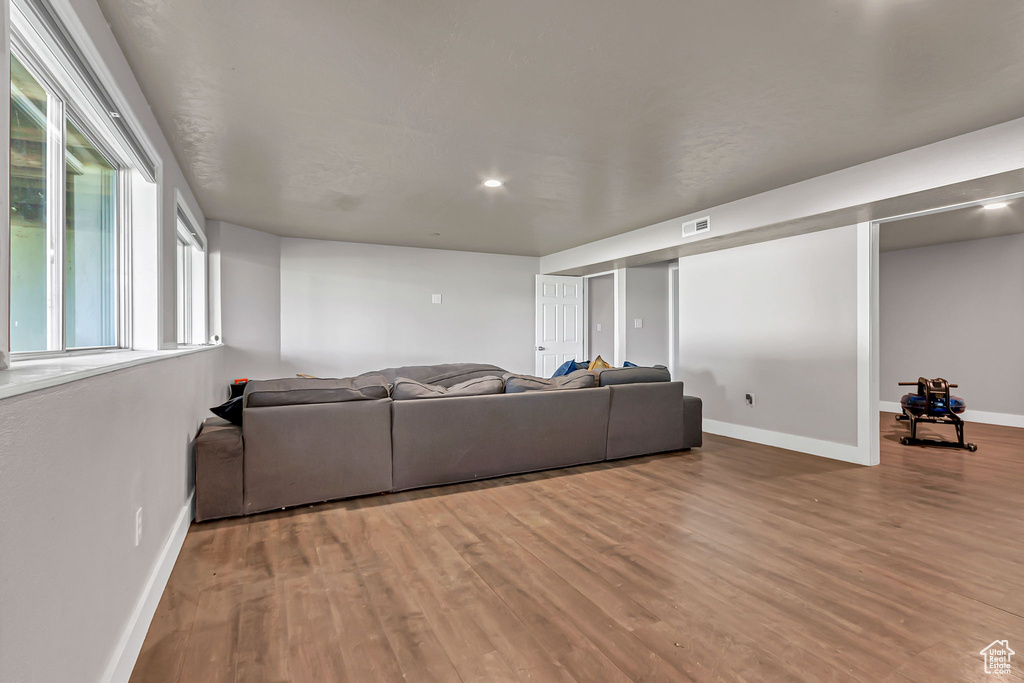 Living area featuring baseboards and wood finished floors