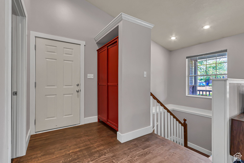 Entryway with dark wood finished floors, baseboards, and recessed lighting