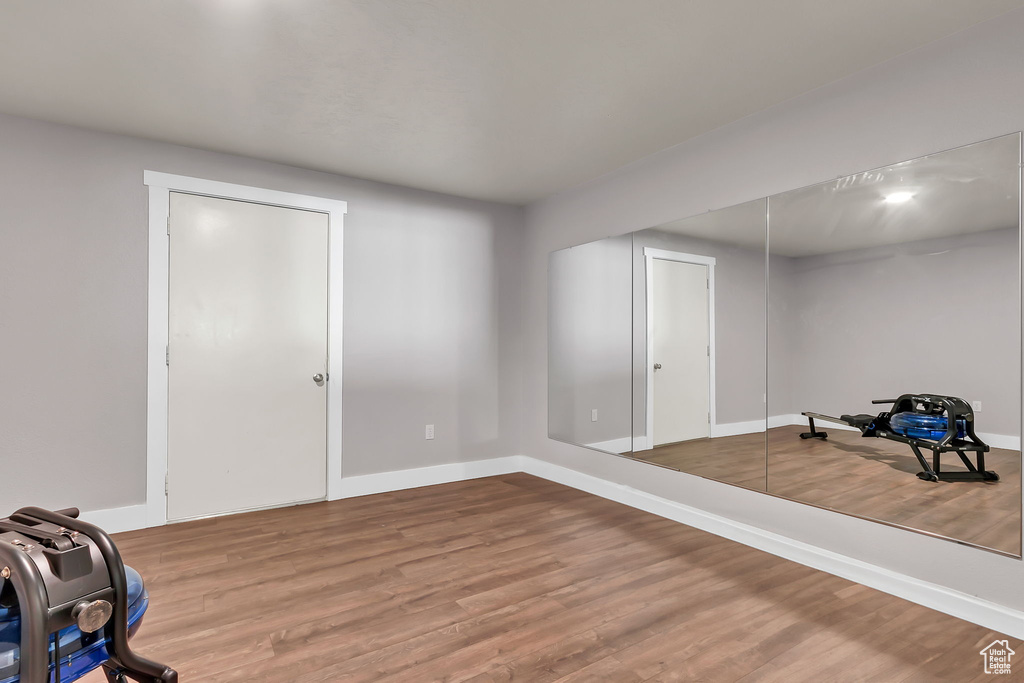 Exercise area featuring wood finished floors and baseboards