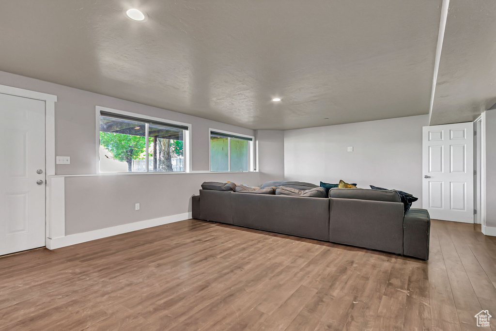 Living room featuring wood finished floors, baseboards, and recessed lighting