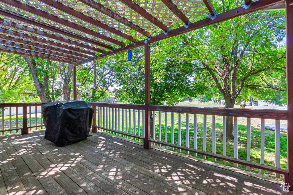 Wooden deck with area for grilling and a pergola