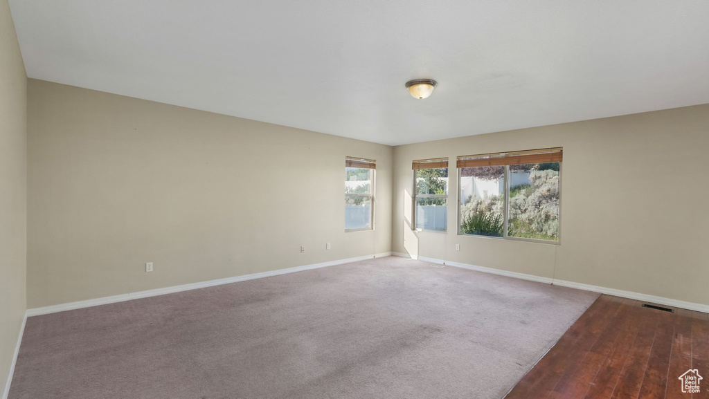 Unfurnished room featuring baseboards and wood finished floors