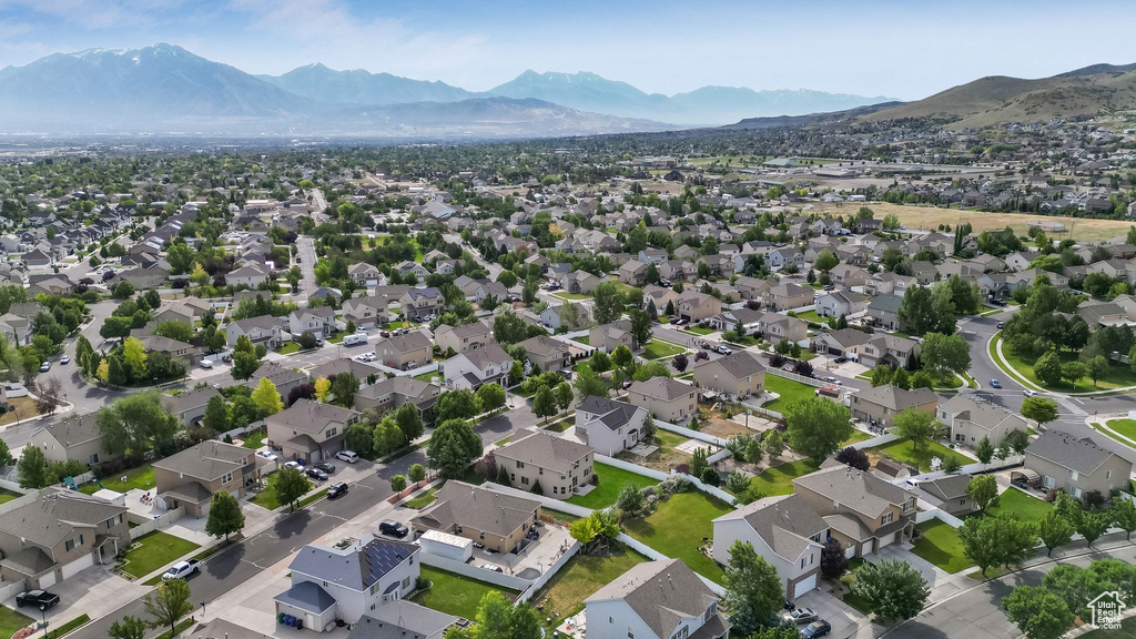 Aerial view of property's location with mountains and nearby suburban area