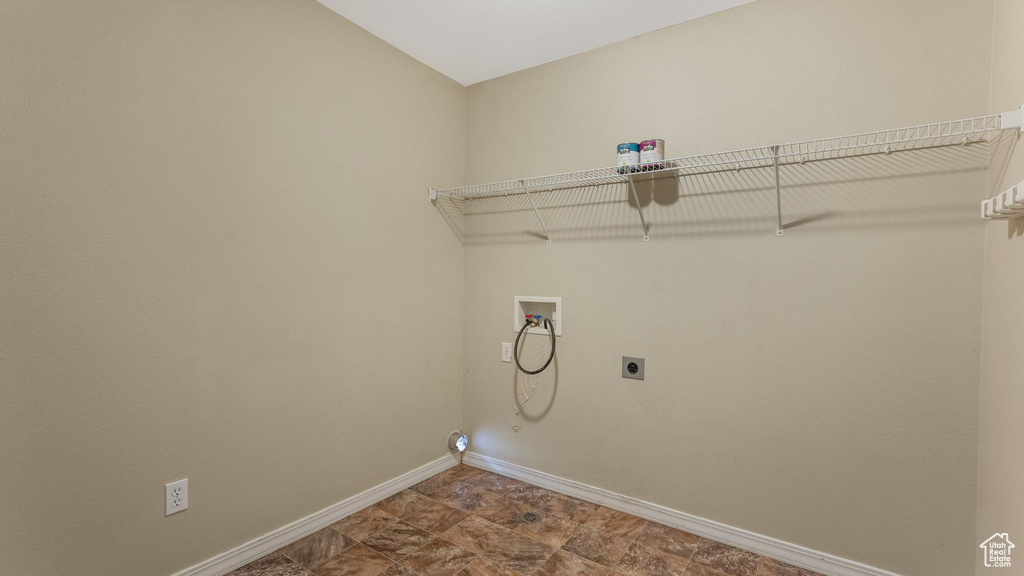 Laundry area with hookup for a washing machine, hookup for an electric dryer, and baseboards