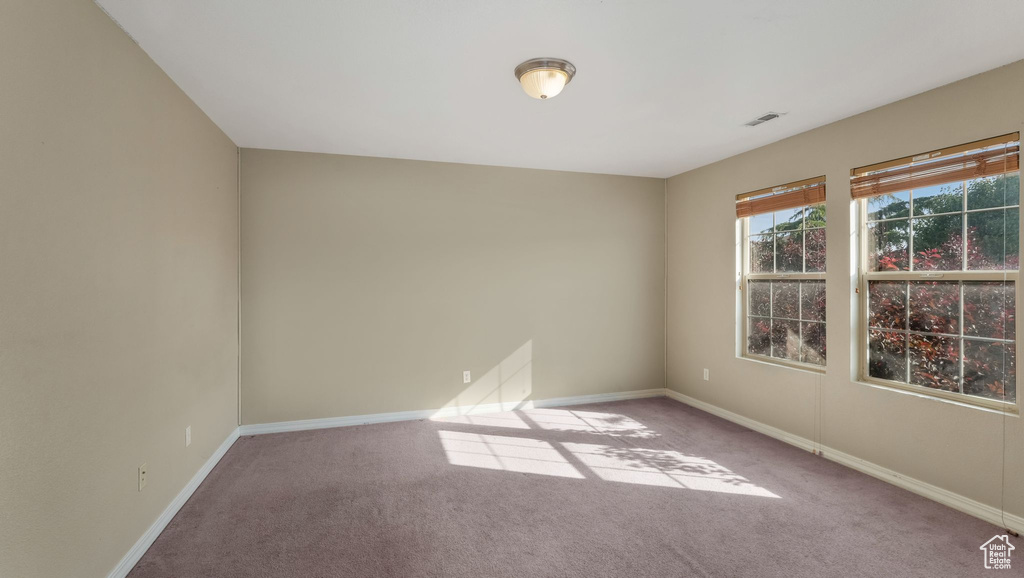 Spare room with carpet and baseboards