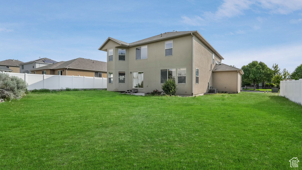 Rear view of house featuring stucco siding