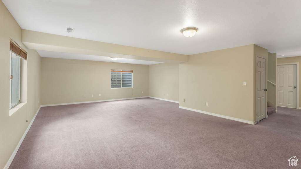 Unfurnished room with carpet floors and baseboards