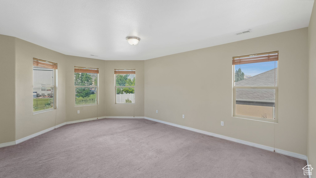 Unfurnished room with carpet flooring and baseboards