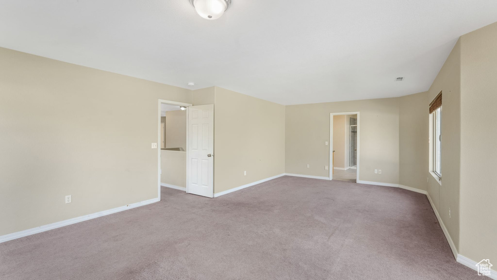 Carpeted empty room with baseboards