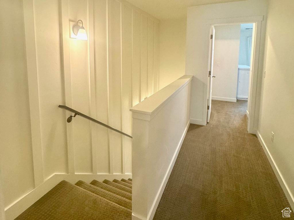 Corridor with carpet and baseboards