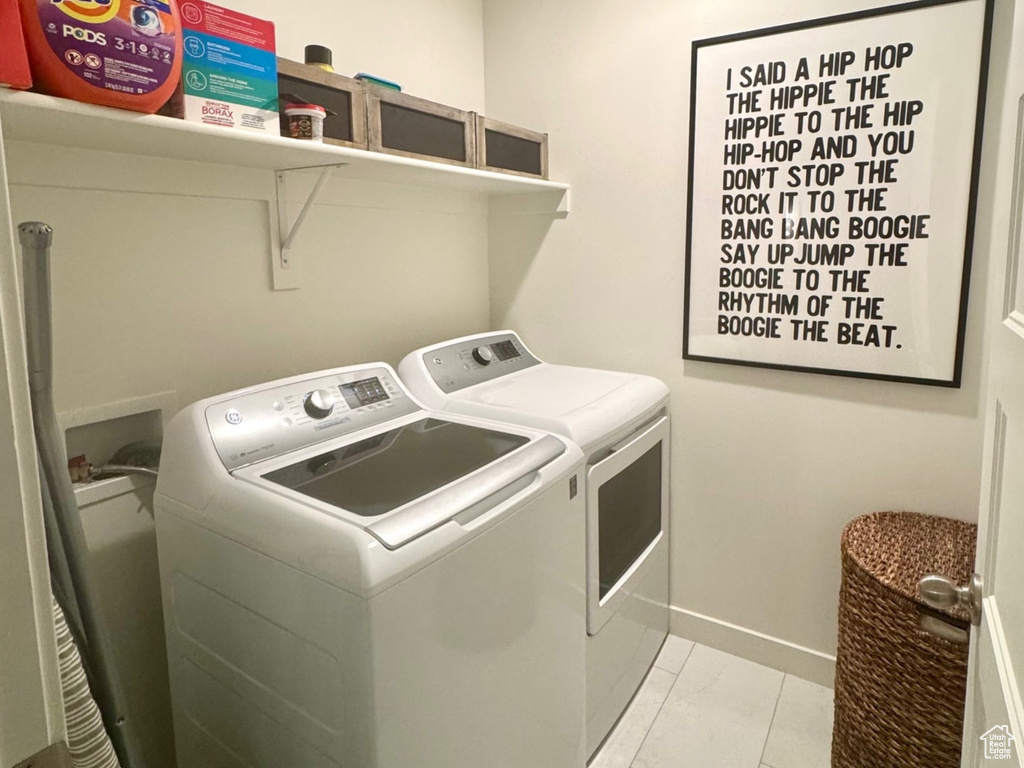 Laundry room featuring separate washer and dryer, light marble finish floors, attic access, baseboards, and recessed lighting