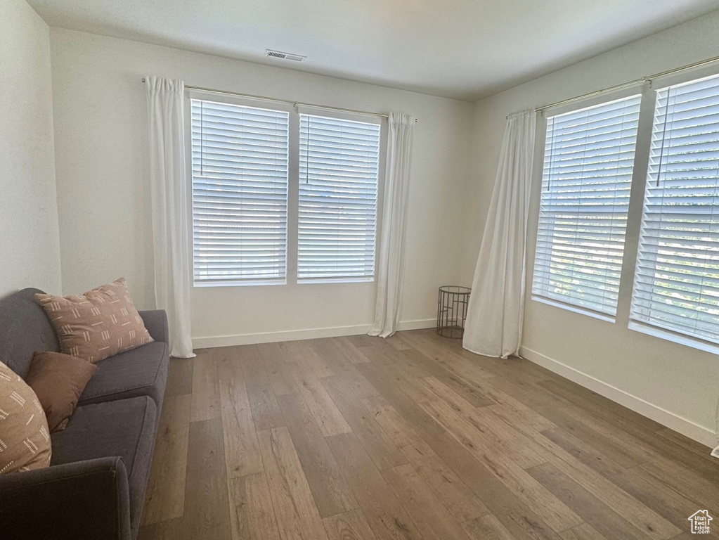 Living room featuring dark wood-style floors, plenty of natural light, and baseboards
