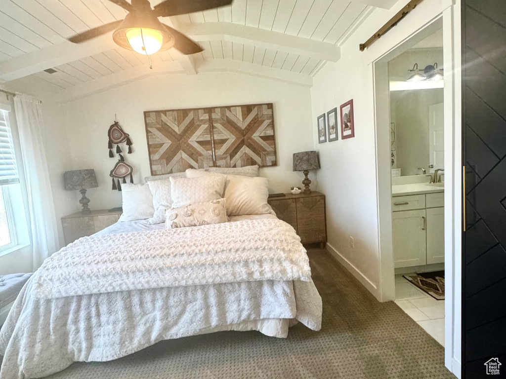 Bedroom featuring a barn door, carpet flooring, wooden ceiling, a ceiling fan, and ensuite bathroom