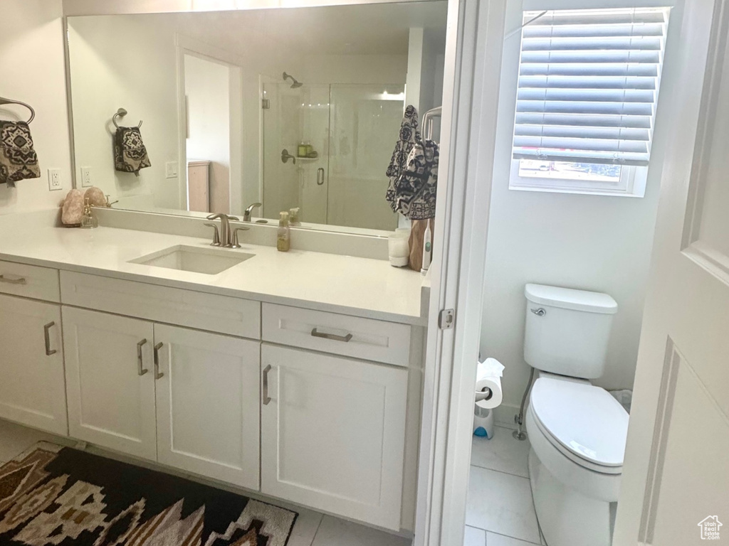 Full bathroom featuring vanity, toilet, and a stall shower