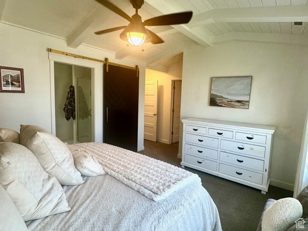 Bedroom with dark carpet, wooden ceiling, and ceiling fan