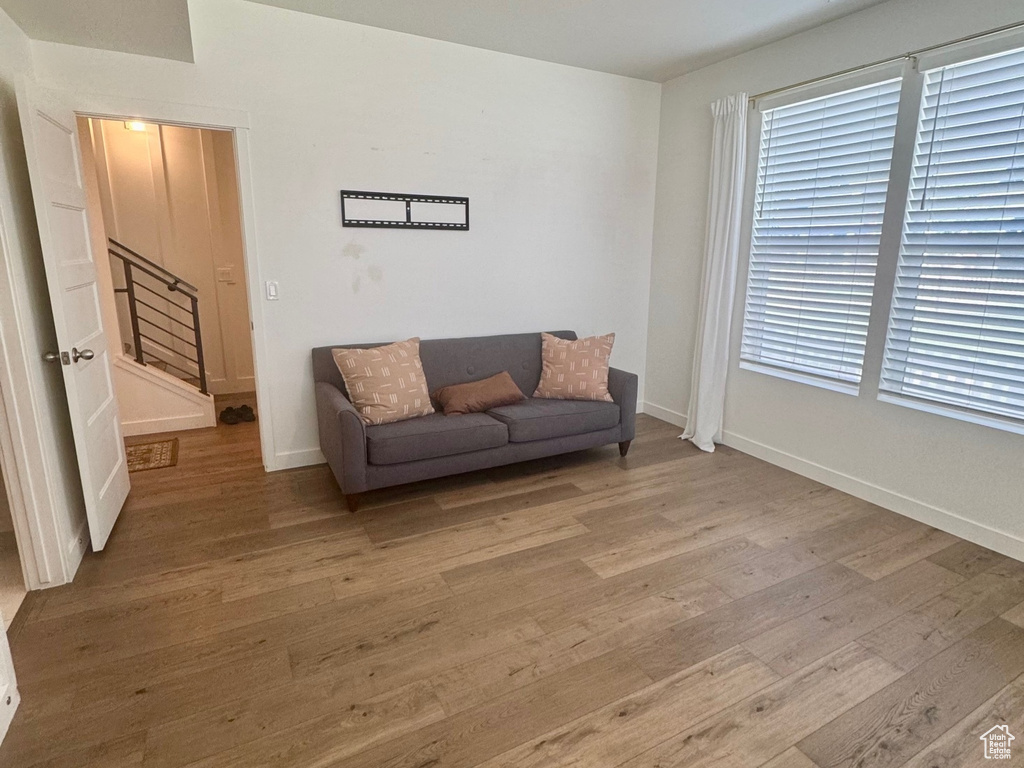 Living area featuring stairs, wood finished floors, and baseboards