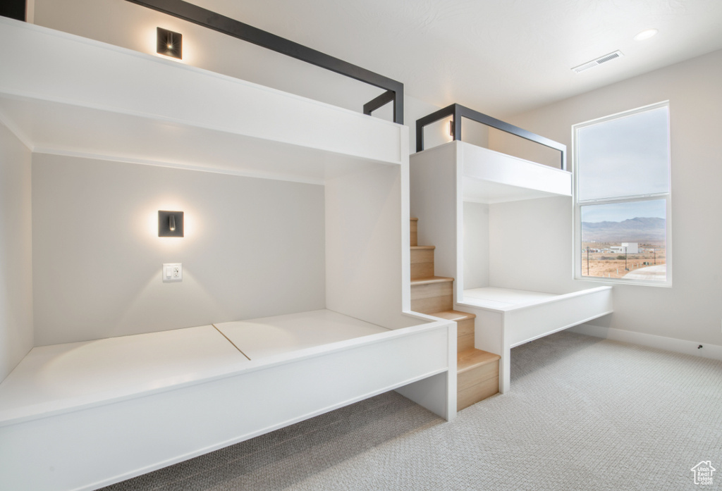Unfurnished bedroom with carpet floors and baseboards