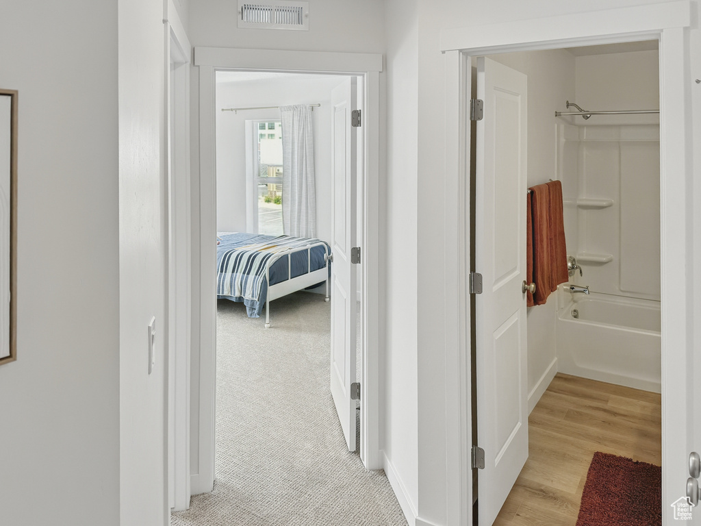 Hall featuring light wood-style flooring and baseboards