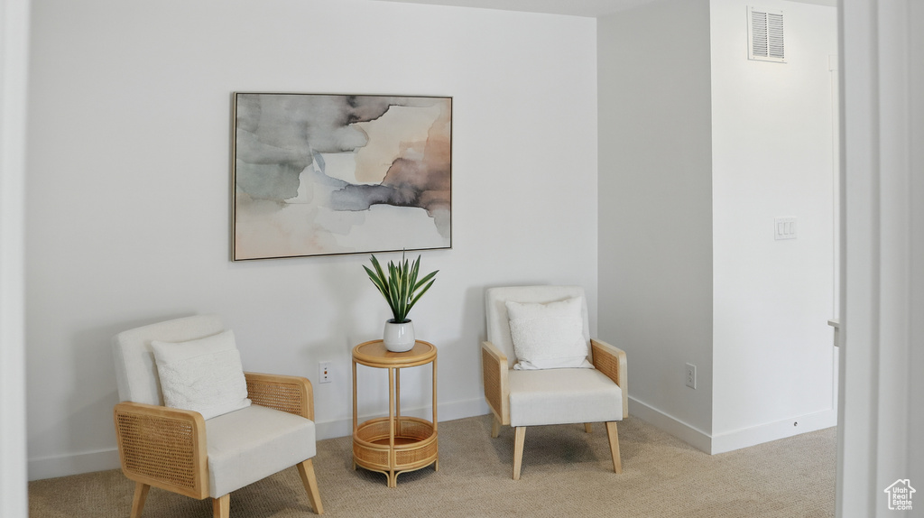 Living area featuring carpet floors and baseboards
