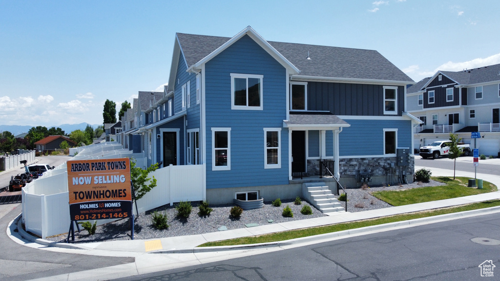 View of front facade featuring a residential view and a shingled roof