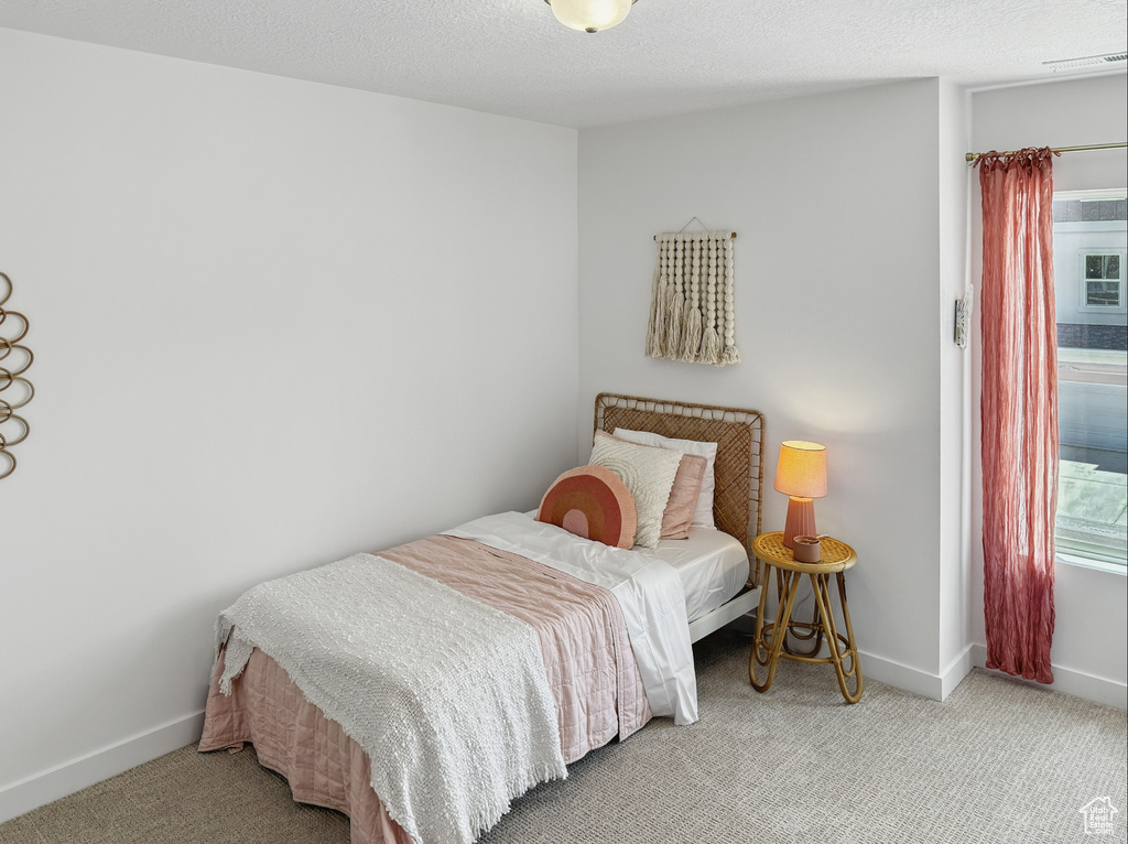 Bedroom with carpet and baseboards