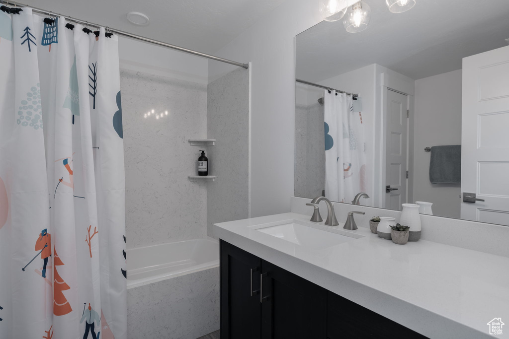 Bathroom featuring vanity and shower / bath combo with shower curtain