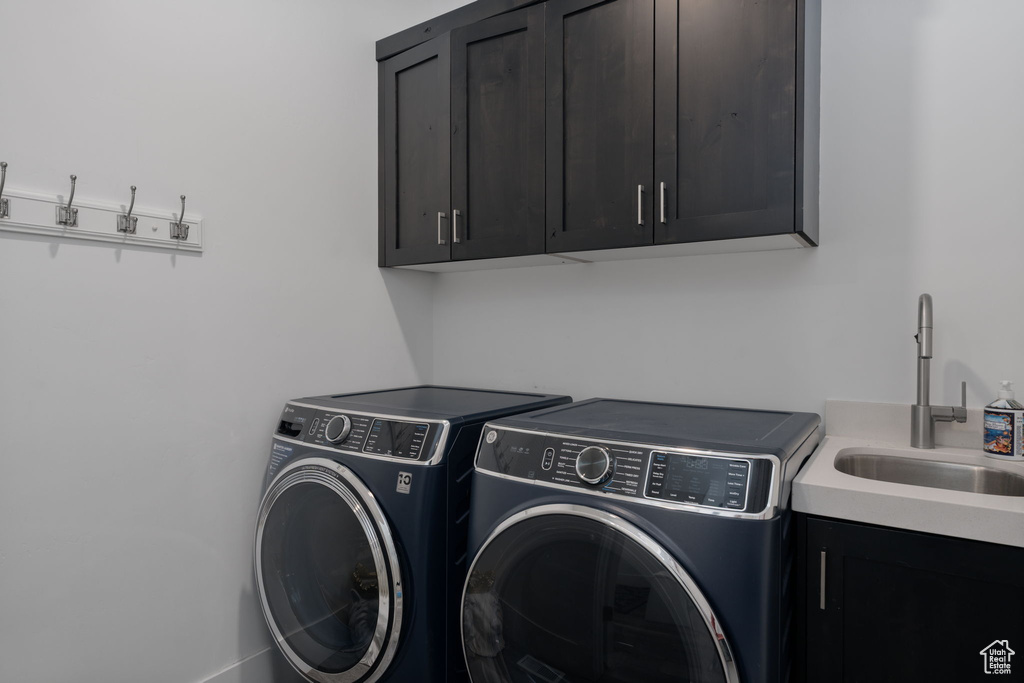 Laundry area featuring cabinet space and independent washer and dryer
