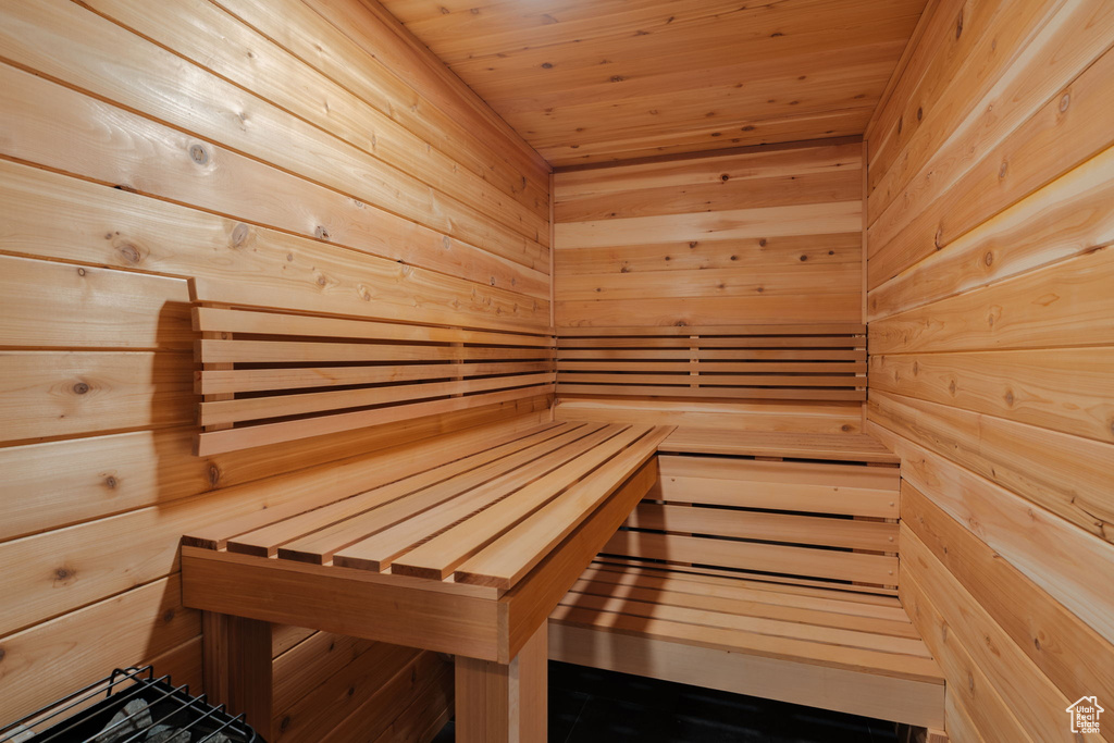 Sauna featuring wooden walls and wood ceiling
