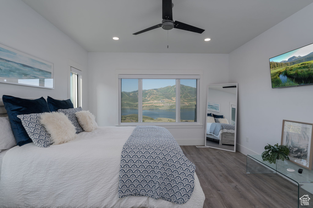 Bedroom with dark wood finished floors, multiple windows, recessed lighting, a ceiling fan, and baseboards