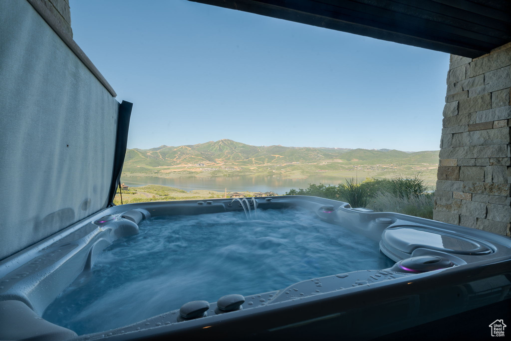Exterior view of a hot tub and a mountain backdrop