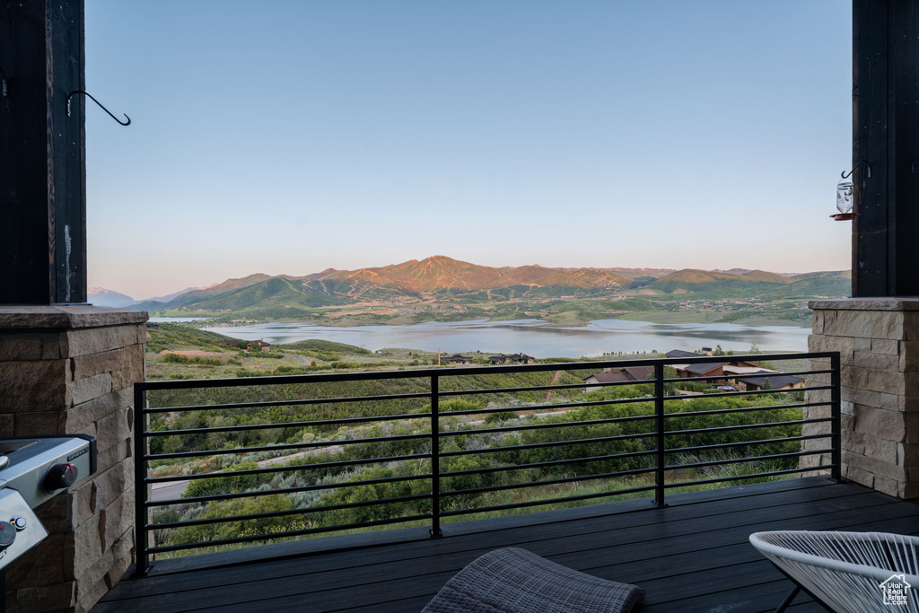 Deck featuring a water and mountain view