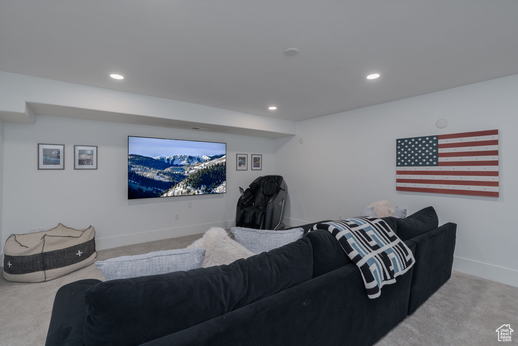 Carpeted living area featuring baseboards and recessed lighting