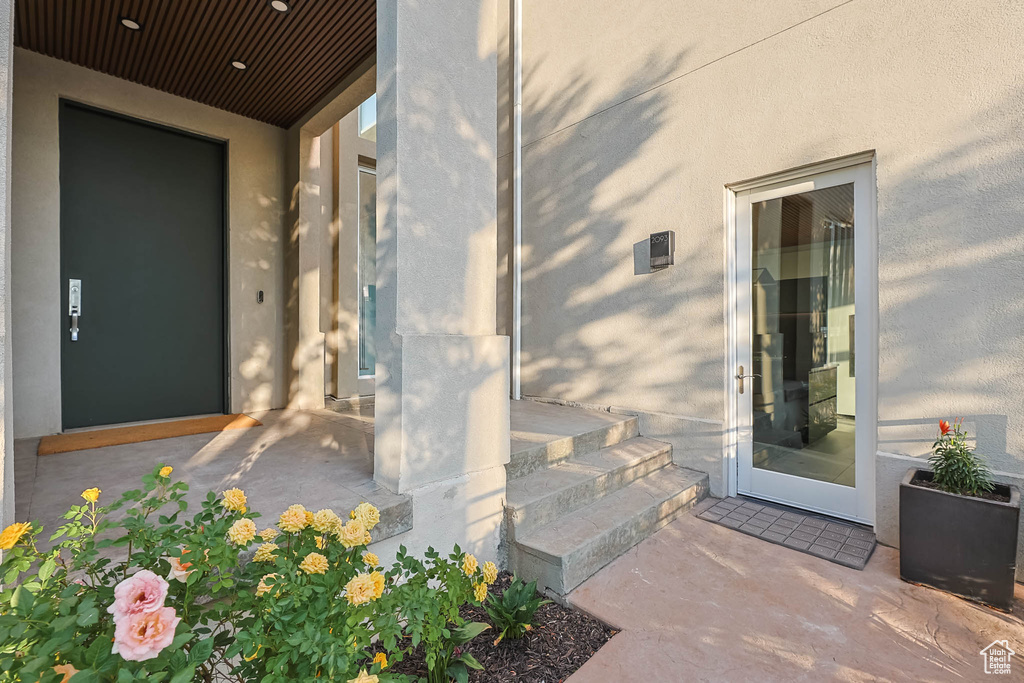 View of exterior entry featuring stucco siding