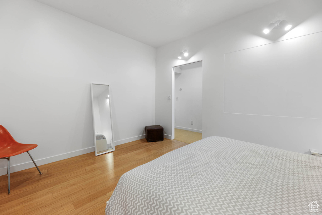Bedroom featuring light wood finished floors and baseboards