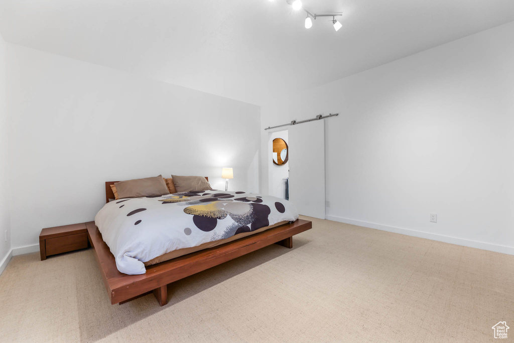 Bedroom featuring carpet and baseboards