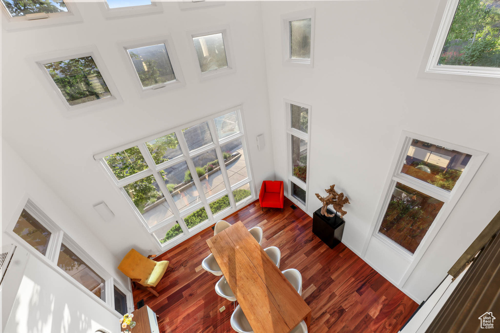 Living area with a high ceiling and dark wood-style floors