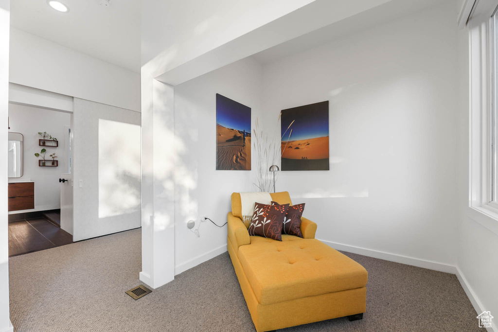 Living area featuring carpet, baseboards, and recessed lighting