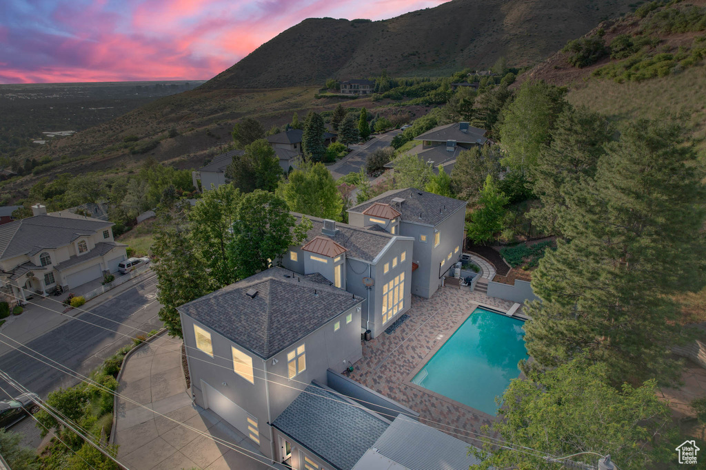 View from above of property with a mountain backdrop and a pool