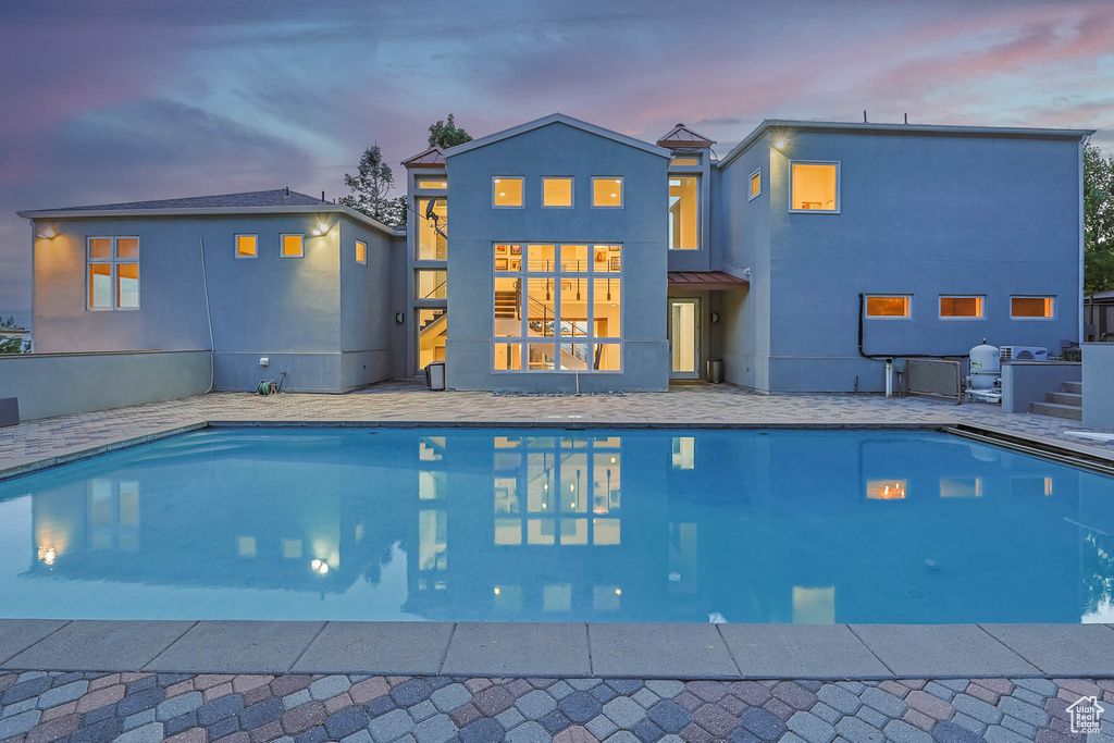 Pool at dusk with an outdoor pool