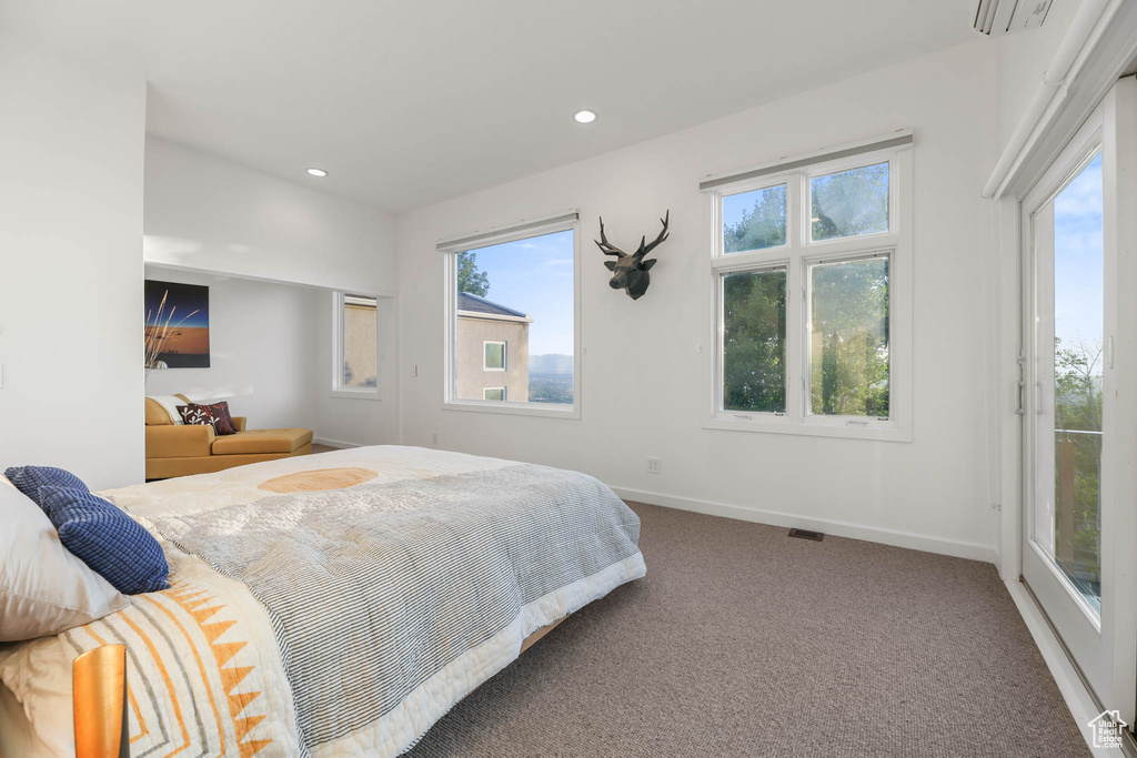 Carpeted bedroom with baseboards and recessed lighting