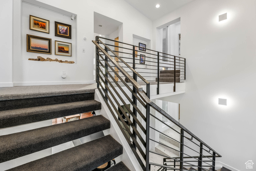 Stairs with baseboards and recessed lighting