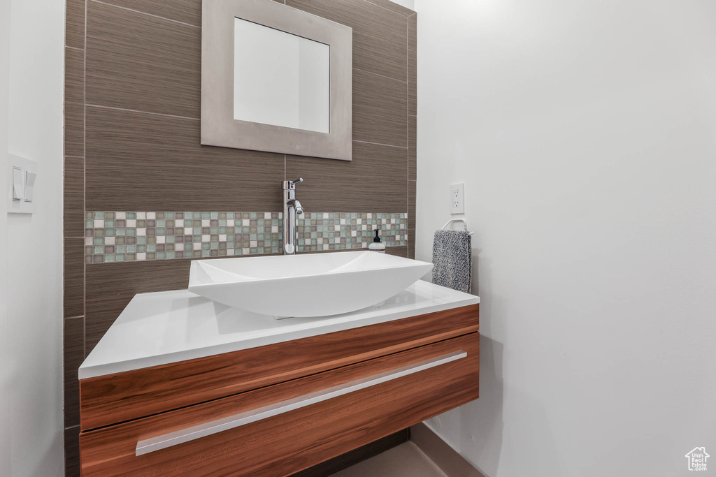Bathroom featuring backsplash and vanity