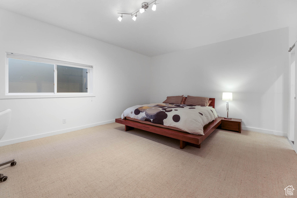Carpeted bedroom with baseboards