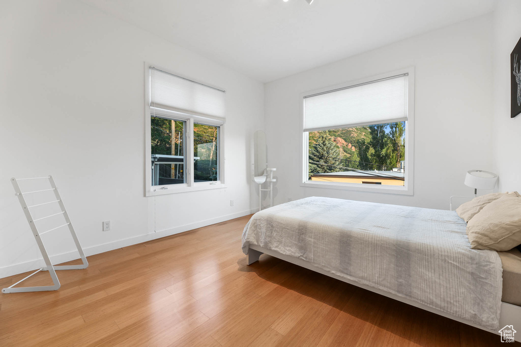 Bedroom featuring light wood finished floors and baseboards