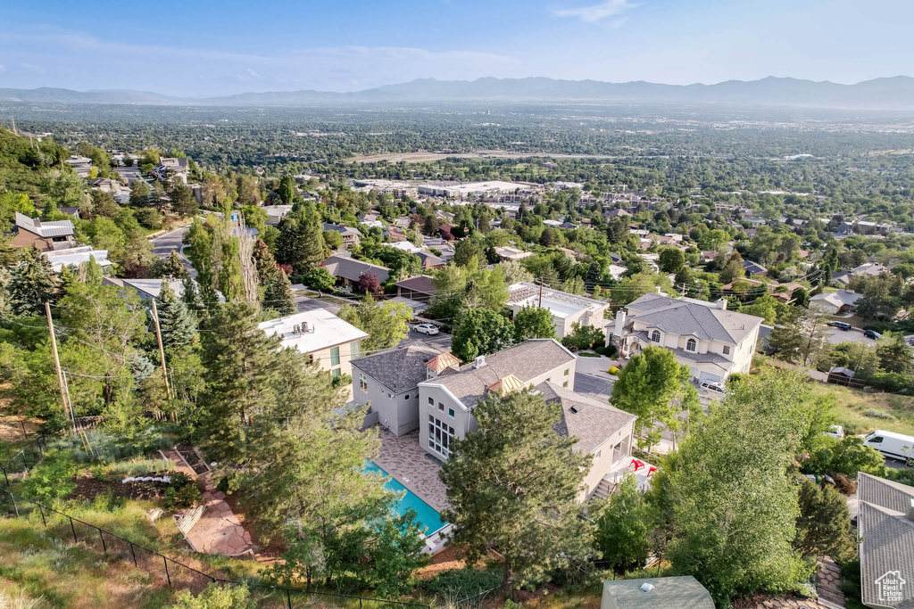 Aerial view of residential area with mountains and a pool