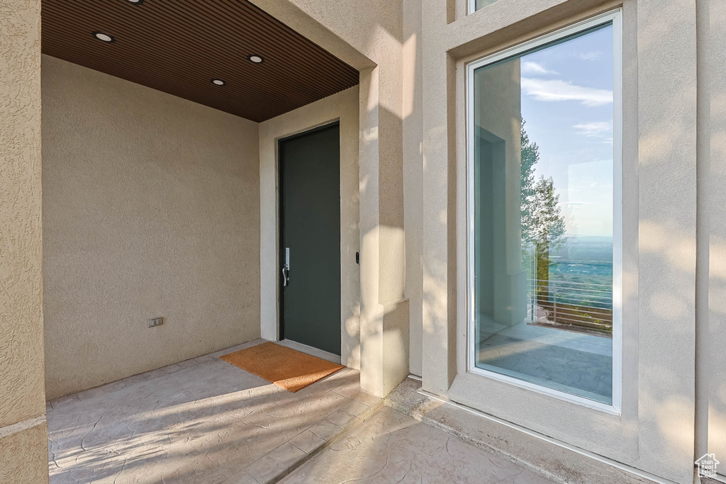 View of exterior entry with stucco siding