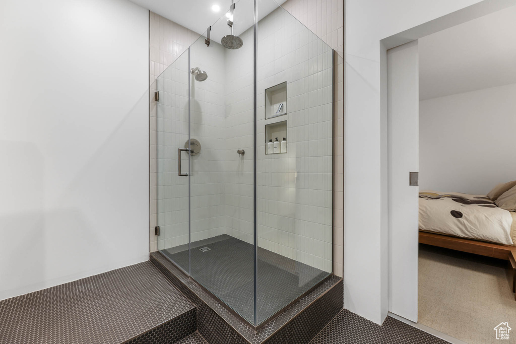 Bathroom featuring a shower stall and ensuite bathroom