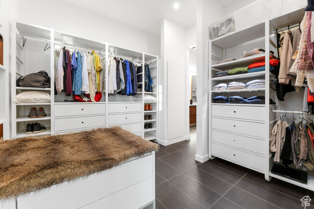 Walk in closet with dark tile patterned floors